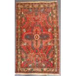 A hand-knotted 20th century Lilihan rug; central stylised crucifix flower head against a