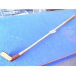 A hickory-shafted golf putter; brown-suede handle and handmade in St Andrews, Scotland, 'The Laird',
