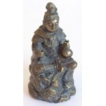 A 19th century Eastern bronze model of a seated figure; well modelled and cast, the figure with