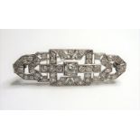 An Art Deco diamond-set brooch of shaped rectangular openwork geometric design, set throughout