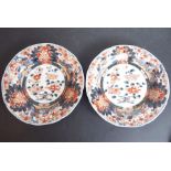 A pair of late 18th/early 19th century Japanese porcelain dishes decorated in the Imari palette with