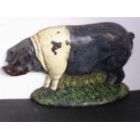 An early 20th century hand-painted cast-iron doorstop modelled as a pig (20cm)