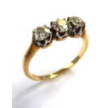 A diamond three-stone ring, the old brilliant-cut diamonds set to the plain 18-carat yellow-gold
