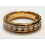 A 14-carat gold half eternity ring set with twelve fine white diamonds (The cost of UK postage via