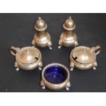 A five-piece silver hallmarked cruet set comprising a pair of pepperettes; a pair of mustards (one