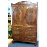 An early 19th century George III period mahogany linen press; the cornice with central figured