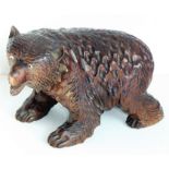 A good and heavy late 19th century carved Black Forest bear; standing four square, with open mouth