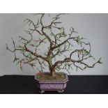 A 20th century pink ground Chinese cloisonné octagonal trough; having a gilded 'bonsai-style' tree