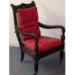 A good mid-19th century Anglo-Indian carved ebony Planter's-style chair; the back and seat squab