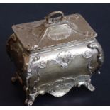An hallmarked silver bombé-shaped tea caddy in mid-18th century style; repoussé decorated with 'C'