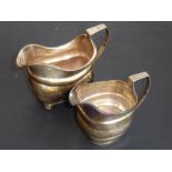 Two hallmarked silver cream jugs, the larger (15cm including handle) with Dublin hallmark, the