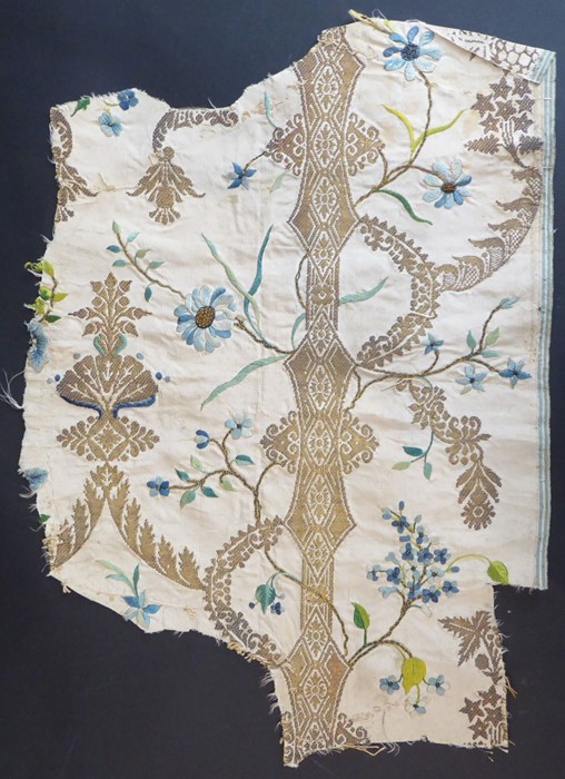 A fragment of, embroidered silk (possibly 1700s); ivory-coloured silk with gold thread in the ‘