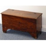 A late 18th/early 19th century elm chest of small proportions, the hinged top above shaped bracket-