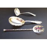 An ornate early 20th century oval serving spoon marked 'sterling' together with one other ladle