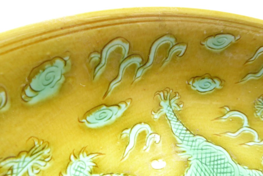 A Chinese porcelain scrafitto dish; three green dragons chasing pearls amongst clouds against an - Image 5 of 9