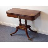 A Regency period rosewood and brass-inlaid fold-over top card table; the central frieze inlaid