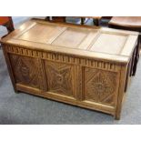 An 18th century panelled oak chest; the three panelled top above an arcaded front frieze with