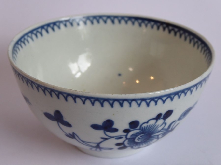 An 18th century Chinese porcelain tea bowl decorated to the exterior with flower heads and sprigs (