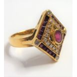 A ruby and diamond-set 18-carat yellow-gold dress ring; the lozenge-shaped plaque centrally set with