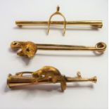 Three yellow-gold bar brooches of hunting interest: one with a fox's head with ruby eyes (fitted