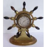 A 19th century novelty brass mantel clock modelled as a ship's wheel with turned varying coloured