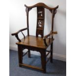 A late 19th century Chinese elm open armchair in 17th century style; yoke-shaped top rail above a