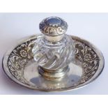 A late 19th century silver-mounted cut-glass inkwell upon a conforming circular silver stand