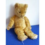 A mid-20th century plush mohair teddy bear; growling mechanism not working and in play-worn