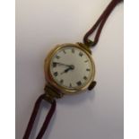 A lady's early 20th century 9-carat gold-cased wristwatch; cream-enamel dial with Roman numerals and