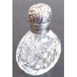 A fine late 19th century cut-glass and silver-mounted scent bottle; the hinged cover decorated