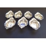 A matched set of seven two-handled boat-shaped silver/sterling silver dishes, each with