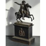 An early/mid-19th century patinated bronze sculpture of Napoleon on horseback; mounted upon a