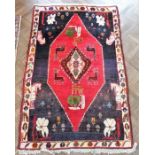 A hand-knotted Persian rug (possibly Shiraz); large central red lozenge with stylised animals and