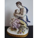 A 19th century hand-decorated Naples porcelain figure model of a scantily clad maiden embracing a