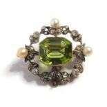 An Edwardian peridot, pearl and diamond-set brooch/pendant, of shaped rectangular openwork design,