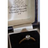 A yellow-metal (hallmarked rubbed) solitaire diamond dress ring; the diamond set into platinum, ring