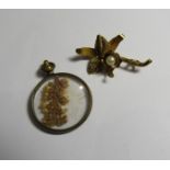 A gold seed pearl flower brooch with faded markings and safety pin clasp, length 3cm, weight 2.2g,