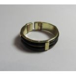 A marked 585 gold and black enamel torque ring. Ring size Q, weight 4.4g.