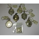 A collection of 7 Deco era silver medals adapted for pendant or fob wear. Weight 38g approx.