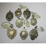 A collection of 8 early 20th century silver medals, adapted for pendant or fob to include silver