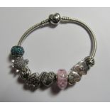 Pandora - A silver Pandora snake chain bracelet with a heart clasp and nine charms and original