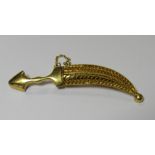 An unmarked gold Arabic sword and scabbard brooch. Measuring 5cm long with a removable half filigree