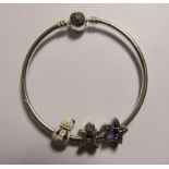 Pandora - A silver Pandora bangle with a heart clasp and three charms and original Pandora box.