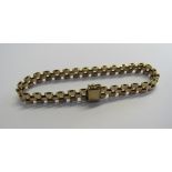 A 9ct gold book chain bracelet, length 16cm approx. width 1.2cm. Hallmarked London 1977, maker AJ,