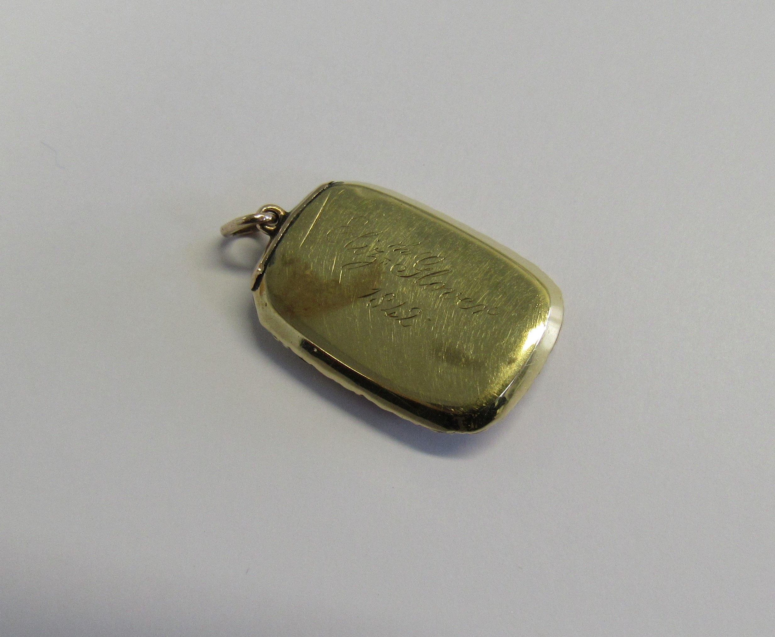 Memorial - A Victorian unmarked gold (tested) pendant piece of oblong form set with a glass - Image 2 of 2