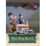 A cast iron money box titled 'Hot Dog Bank'