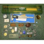 A boxed digimatic caliper and a linex measure. Together with a box of items to include metal badges,