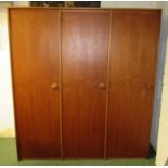 A Stag three door teak wardrobe, one long hanging unit, one top shelf unit and one four shelved unit