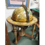 A Drinks cabinet in the form of the World Globe, opening to reveal glasses and compartments for