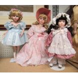 A collection of three porcelain dolls, all with stands, unboxed, one dressed as a ballerina